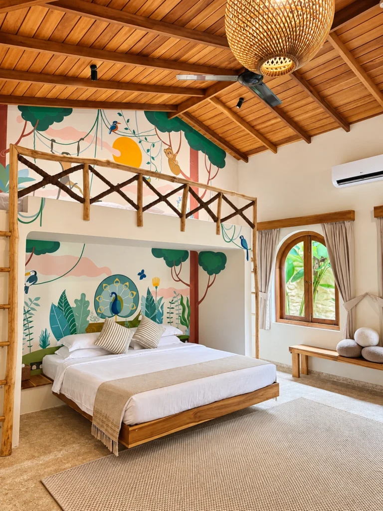 A playful family bedroom with a kids loft and jungle mural, designed for stays with children at The Nest Sri Lanka.