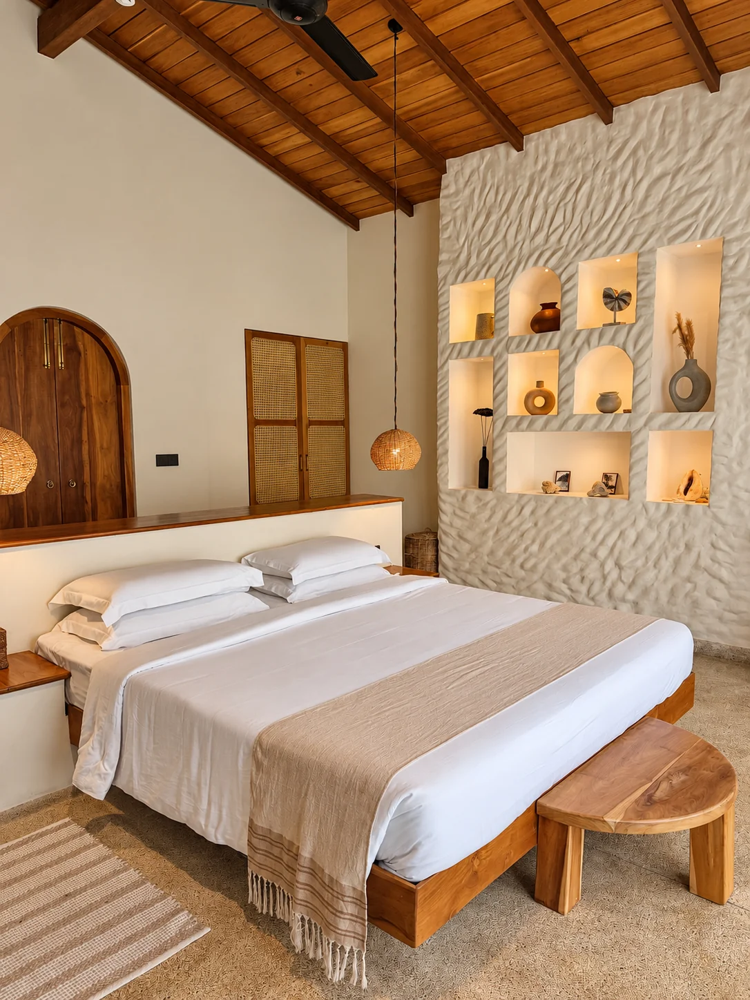 Master bedroom with timber ceiling, handcrafted lighting and textured feature wall at The Nest Sri Lanka.