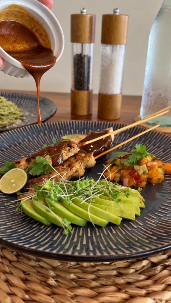 Satay chicken skewers with a creamy peanut sauce.