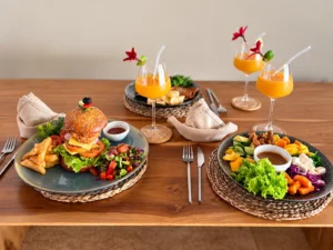 Freshly prepared gourmet burger, colourful salad and tropical drinks served by the private villa chef at The Nest Sri Lanka, Hiriketiya.